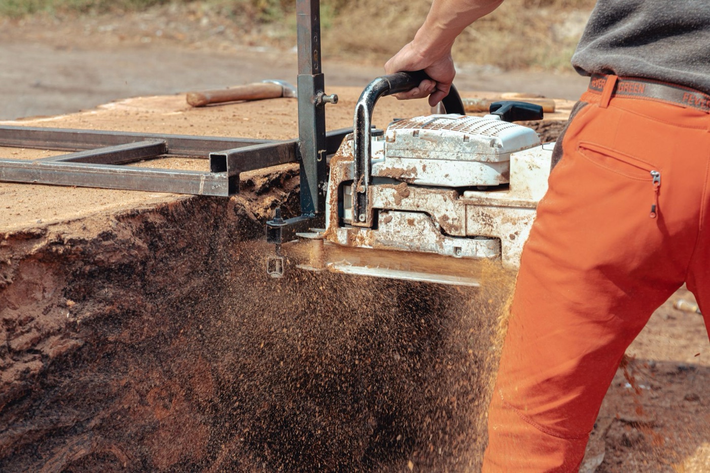 A construction worker using a power saw safely on a worksite