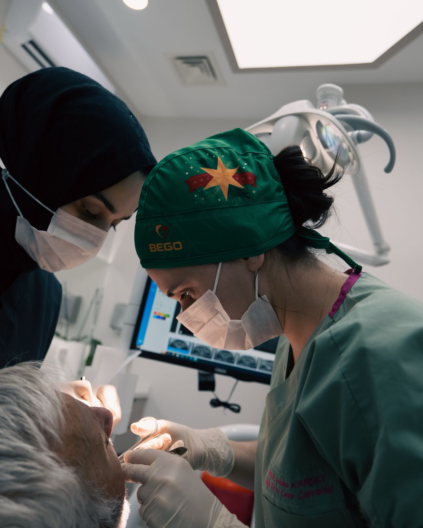 A dentist and assistant caring for a patient in a modern dental clinic