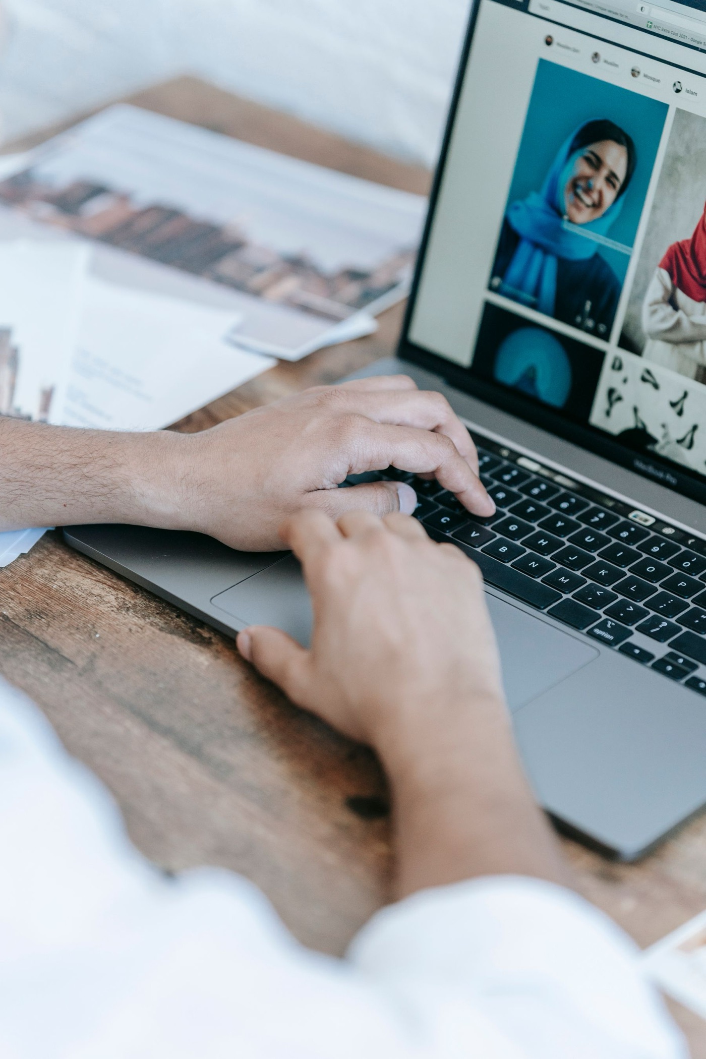 A creative professional editing a photography portfolio on a laptop