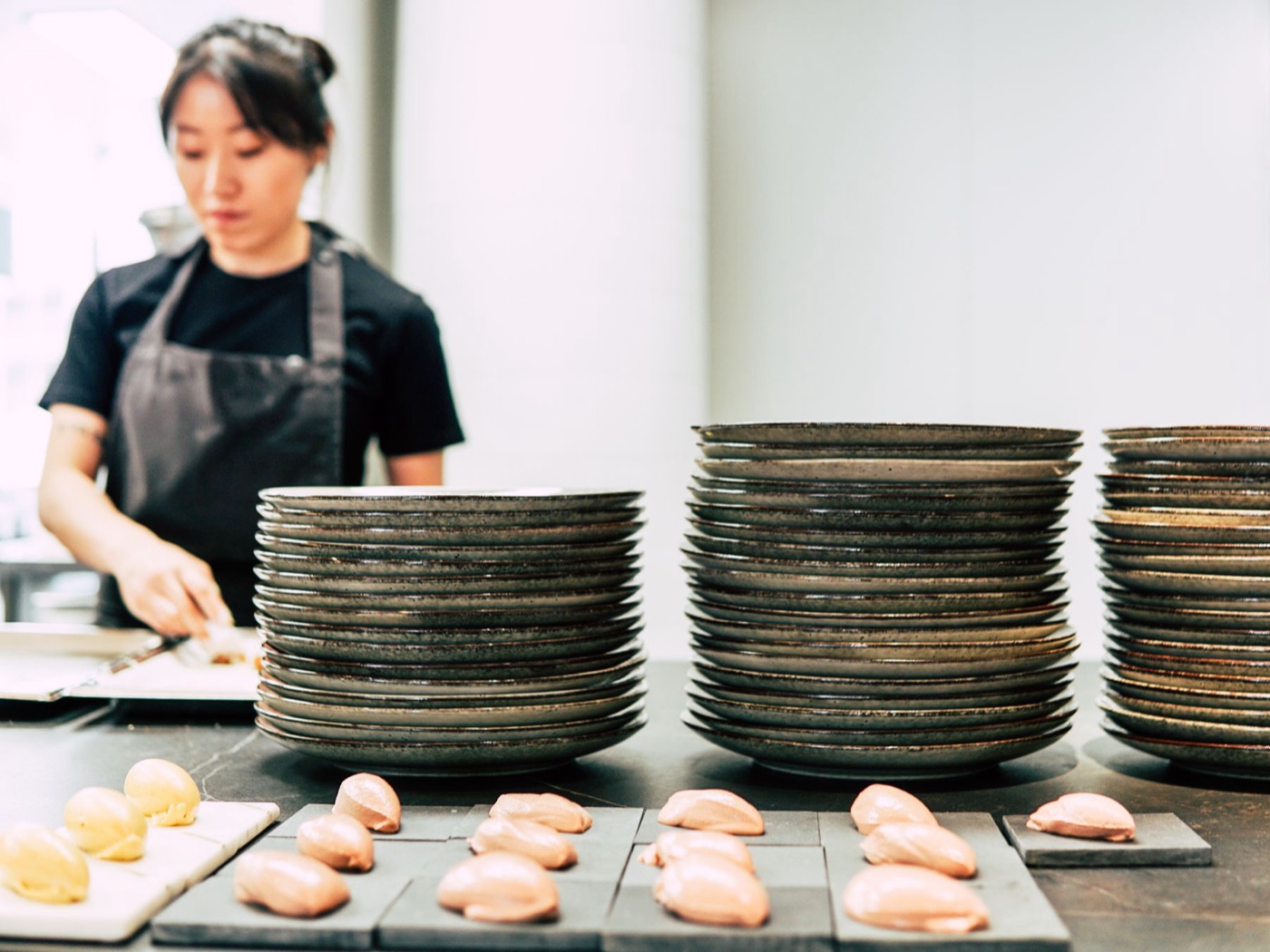 A restaurant chef arranging finished plates for service